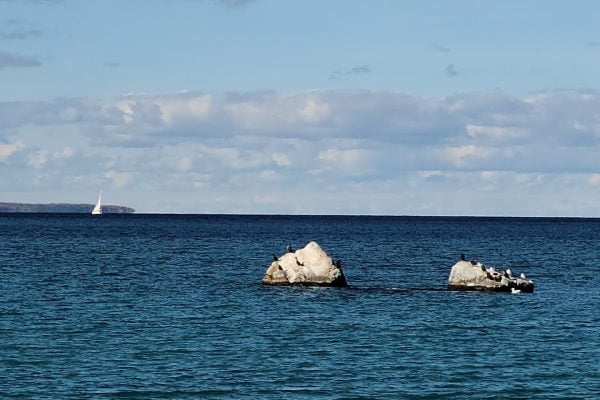 An image of the two sisters rocks off the shore of memorial park in Meaford